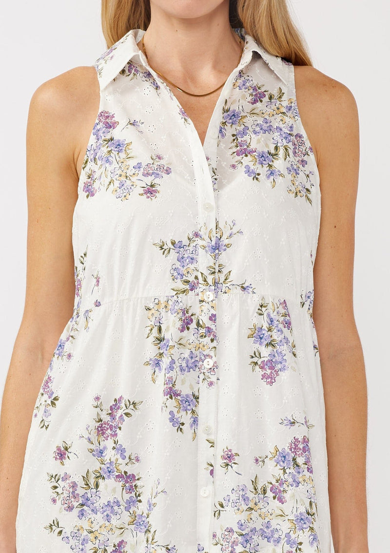 [Color: Off White/Lilac] A detail image of a blonde model wearing a sleeveless purple floral midi shirt dress. The dress features embroidered eyelets, a collared neckline, a button-front design, and a tiered skirt. Ideal for weddings, Easter, or other special occasions.