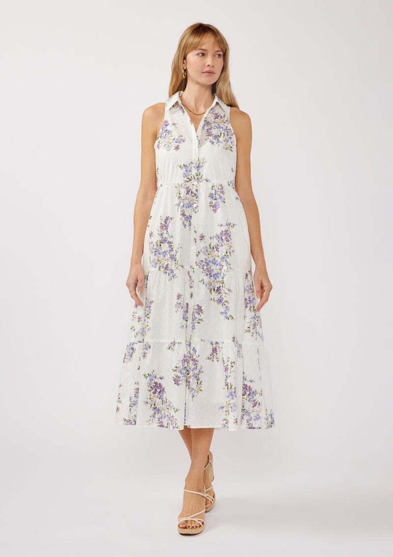 [Color: Off White/Lilac] A front-facing image of a blonde model wearing a sleeveless purple floral midi shirt dress. The dress features embroidered eyelets, a collared neckline, a button-front design, and a tiered skirt. Ideal for weddings, Easter, or other special occasions.