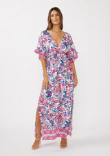 [Color: Natural/Dusty Pink] A front facing image of a brunette model wearing a pink and blue floral print kimono sleeve maxi dress with a ruffle trim, smocked waist, double v-neckline, and side slits. Perfect for spring special occasions. 
