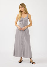 [Color: Dove Grey] A front facing image of a brunette model wearing a classic grey maxi dress. This linen blend maxi features a button front, side pockets, and a smocked back.