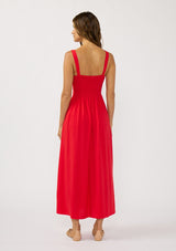 [Color: Tomato] A back facing image of a brunette model wearing a classic red maxi dress. This linen blend maxi features a button front, side pockets, and a smocked back.