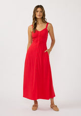 [Color: Tomato] A front facing image of a brunette model wearing a classic red maxi dress. This linen blend maxi features a button front, side pockets, and a smocked back.