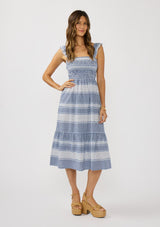 [Color: Navy/White] A front facing image of a brunette model wearing a blue and white checkered midi dress with stripes. Featuring chic ruffled elastic straps, a smocked bust, side pockets, and a tiered skirt. 
