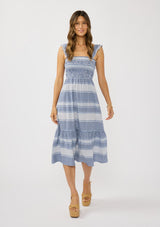[Color: Navy/White] A front facing image of a brunette model wearing a blue and white checkered midi dress with stripes. Featuring chic ruffled elastic straps, a smocked bust, side pockets, and a tiered skirt. 