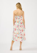 [Color: Ivory/Fuchsia] A back facing image of a blonde model wearing a spring floral midi dress with adjustable spaghetti straps, quilted bodice, and side pockets.