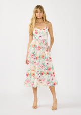 [Color: Ivory/Fuchsia] A front facing image of a blonde model wearing a spring floral midi dress with adjustable spaghetti straps, quilted bodice, and side pockets.