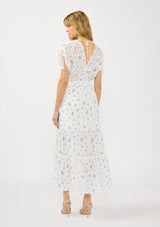 [Color: White/Blue] A back facing image of a blonde model wearing a spring white and blue floral maxi dress with short dolman sleeves, tassel ties, a v neckline, and a smocked waist. 