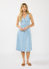 [Color: Light Wash] A front facing image of a blonde model wearing a denim midi dress with a v neckline and button front. 