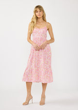 [Color: Natural/Dusty Rose] A front facing image of a blonde model wearing a pink floral midi dress with a v neckline, spaghetti straps, a smocked back, and side pockets.