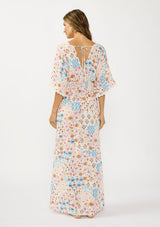 [Color: Ivory/Orange] A back facing image of a brunette model wearing a blue and orange kimono sleeve maxi dress with a deep v neckline, smocked waist, tie back detail, and side slits. 