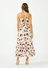 [Color: Peach/Plum] A back facing image of a brunette model wearing a pink and purple floral maxi dress with a pleated design, v neckline, spaghetti straps, and a cross back with tie back detail. 
