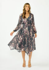 [Color: Grey/Dusty Rose] A front facing image of a brunette model wearing a grey floral handkerchief dress with clipped lurex, a surplice v neckline, long sleeves, and an elastic waist. 