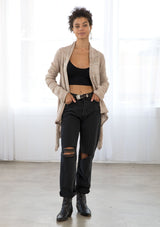 [Color: Pale Mauve] A front facing image of a brunette model wearing a pointelle knit cardigan with metallic thread details, a waterfall front, and long cozy sleeves. 