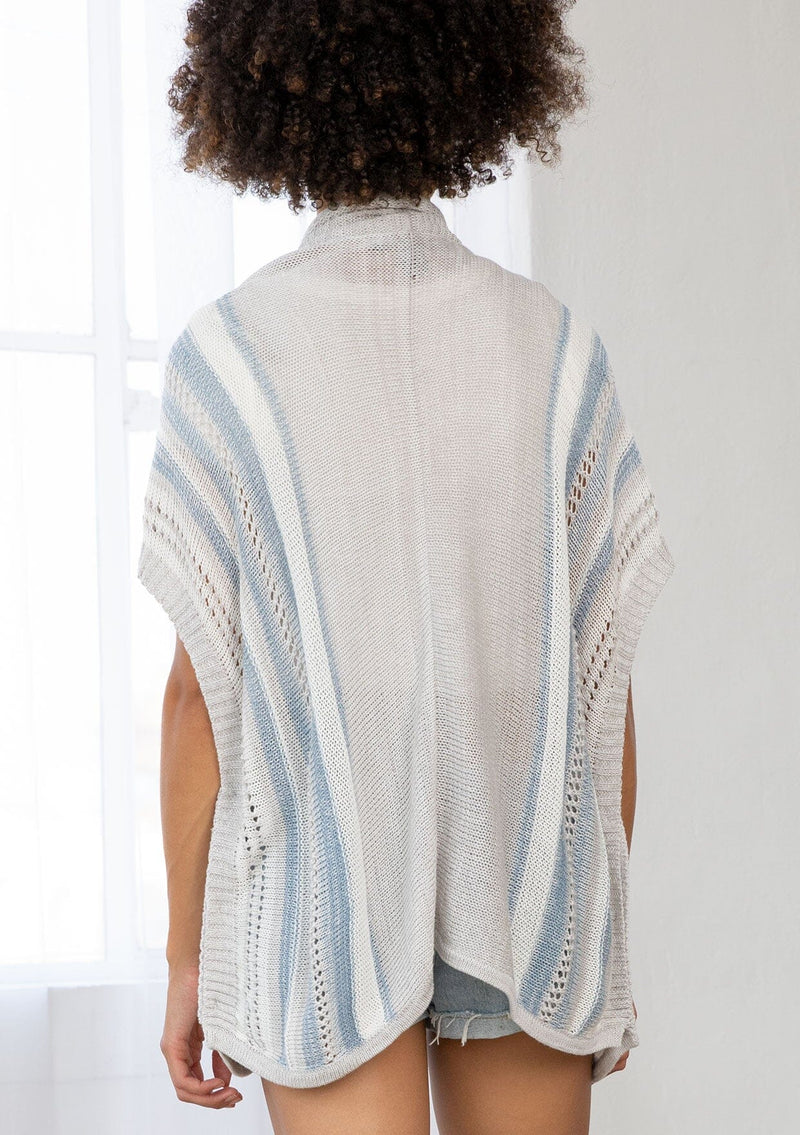 [Color: Silver/Blue] A back facing image of a brunette model wearing a lightweight striped cardigan with open knit details, short dolman sleeves, and side button closure. An effortless layer for warm weather days. 