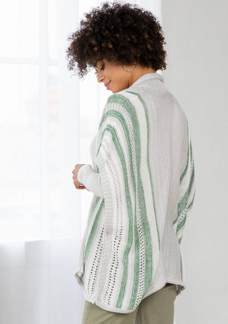[Color: Silver/Green] A side facing image of a brunette model wearing a lightweight striped cardigan with open knit details, short dolman sleeves, and side button closure. An effortless layer for warm weather days. 