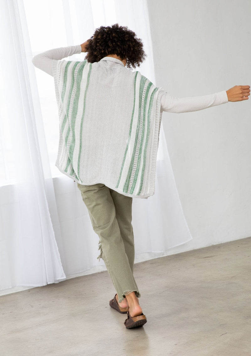 [Color: Silver/Green] A back facing image of a brunette model wearing a lightweight striped cardigan with open knit details, short dolman sleeves, and side button closure. An effortless layer for warm weather days. 