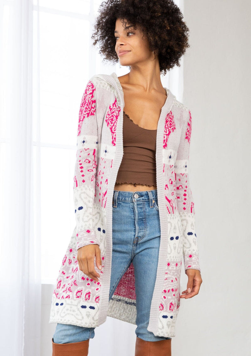 [Color: Orchid/Raspberry] A front facing image of a brunette model wearing a vibrant boho patterned knit cardigan with long cozy sleeves, open front, and hoodie. An effortless statement sweater for easy layering.  