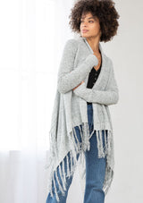 [Color: Grey/Ivory] A front facing image of a marled knit cardigan with a shawl waterfall collar with a fringe hem. A boho chic cardigan for the fall season. 