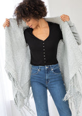 [Color: Grey/Ivory] A front facing image of a marled knit cardigan with a shawl waterfall collar with a fringe hem. A boho chic cardigan for the fall season. 