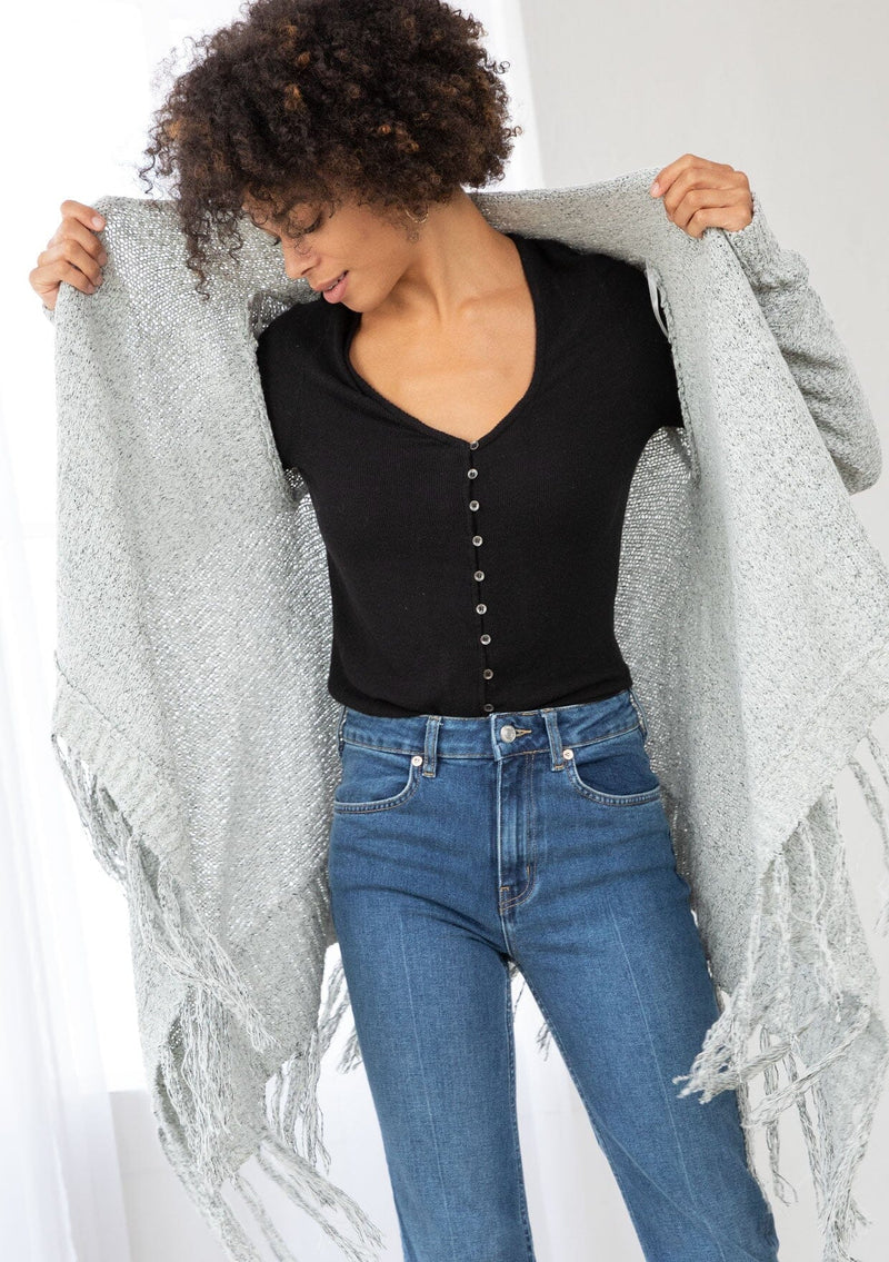[Color: Grey/Ivory] A front facing image of a marled knit cardigan with a shawl waterfall collar with a fringe hem. A boho chic cardigan for the fall season. 