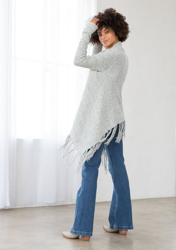 [Color: Grey/Ivory] A back facing image of a marled knit cardigan with a shawl waterfall collar with a fringe hem. A boho chic cardigan for the fall season. 