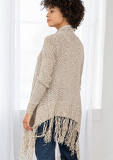 [Color: Natural/Cream] A back facing image of brunette model wearing a marled knit cardigan with a fringe hem, shawl collar, and a cozy, relaxed fit. A versatile fall cardigan. 
