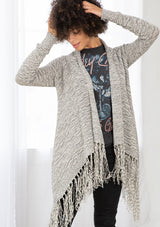 [Color: Black/Off White] A front facing image of brunette model wearing a marled knit cardigan with a fringe hem, shawl collar, and a cozy, relaxed fit. A versatile fall cardigan. 