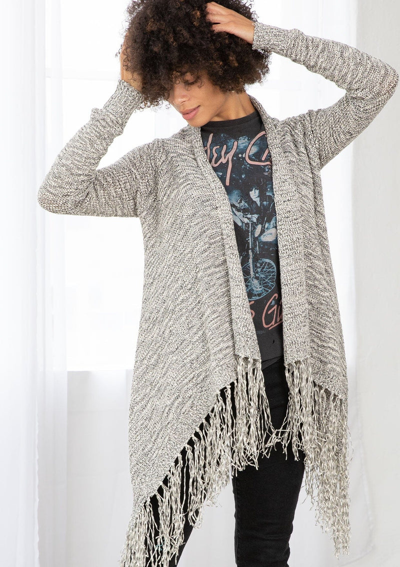 [Color: Black/Off White] A front facing image of brunette model wearing a marled knit cardigan with a fringe hem, shawl collar, and a cozy, relaxed fit. A versatile fall cardigan. 