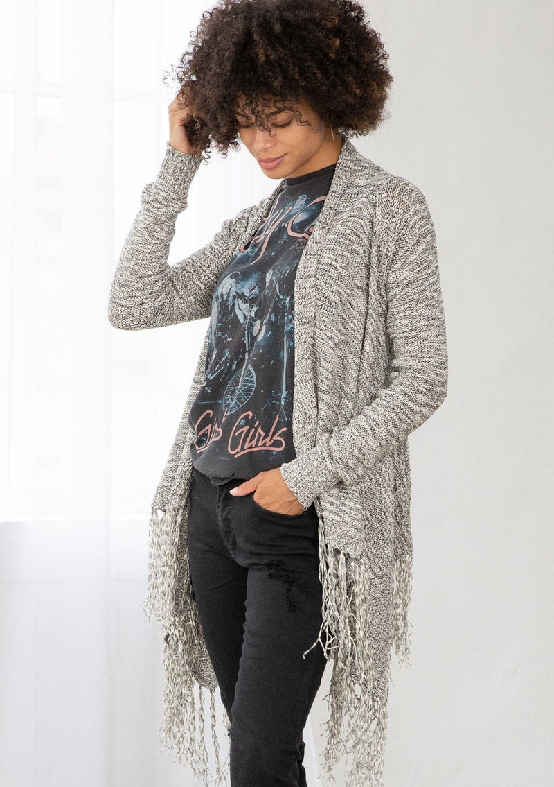 [Color: Black/Off White] A front facing image of brunette model wearing a marled knit cardigan with a fringe hem, shawl collar, and a cozy, relaxed fit. A versatile fall cardigan. 