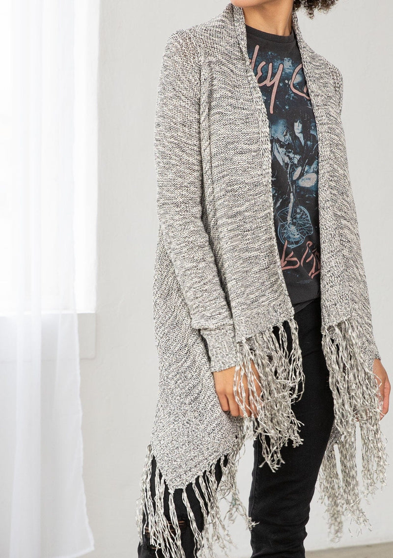 [Color: Black/Off White] A front facing image of brunette model wearing a marled knit cardigan with a fringe hem, shawl collar, and a cozy, relaxed fit. A versatile fall cardigan. 