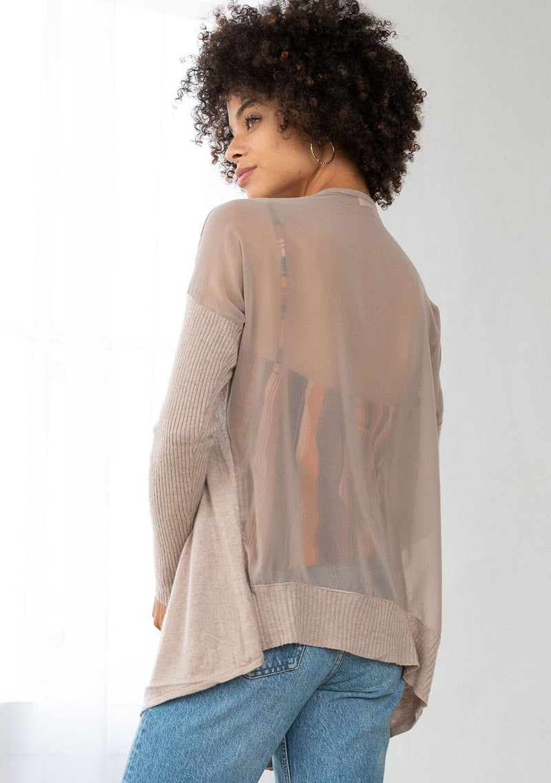 [Color: Mushroom] A back facing image of a brunette model wearing a beige cardigan with a sheer back. Featuring cozy ribbed sleeves, and open front, and shawl collar. A casual fall style for effortless layering. 