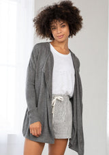 [Color: Dark Grey] A front facing image of a brunette model wearing a grey cardigan with a sheer back. Featuring cozy ribbed sleeves, and open front, and shawl collar. A casual fall style for effortless layering. 