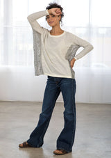 [Color: Grey/Ivory] A front facing image of brunette model wearing a boho striped pullover with a crochet accent.