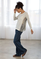 [Color: Grey/Ivory] A side facing image of brunette model wearing a boho striped pullover with a crochet accent.