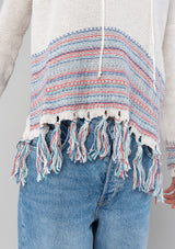 [Color: Off White/Navy] A white and blue bohemian fringed beach sweater with long sleeves and a hoodie. 