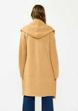 [Color: Camel] A back facing image of a brunette model wearing a best selling oversized cardigan in a camel brown color. A cozy and thick sweater coat with a hood, an open front, side pockets, a cocoon style silhouette, and a mid length hem. 