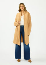 [Color: Camel] A front facing image of a brunette model wearing a best selling oversized cardigan in a camel brown color. A cozy and thick sweater coat with a hood, an open front, side pockets, a cocoon style silhouette, and a mid length hem. 