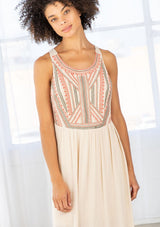 [Color: Natural/Olive/Coral] A detail image of a brunette model wearing a beige sleeveless maxi dress with a coral embroidered bodice and a scoop neckline. 
