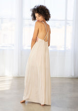 [Color: Natural/Olive/Coral] A front facing image of a brunette model wearing a beige sleeveless maxi dress with a cross back detail. 