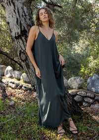 [Color: Military] An army green harem maxi dress. This billowy maxi tank top dress features a deep v neckline, adjustable spaghetti straps, and a cocoon fit.