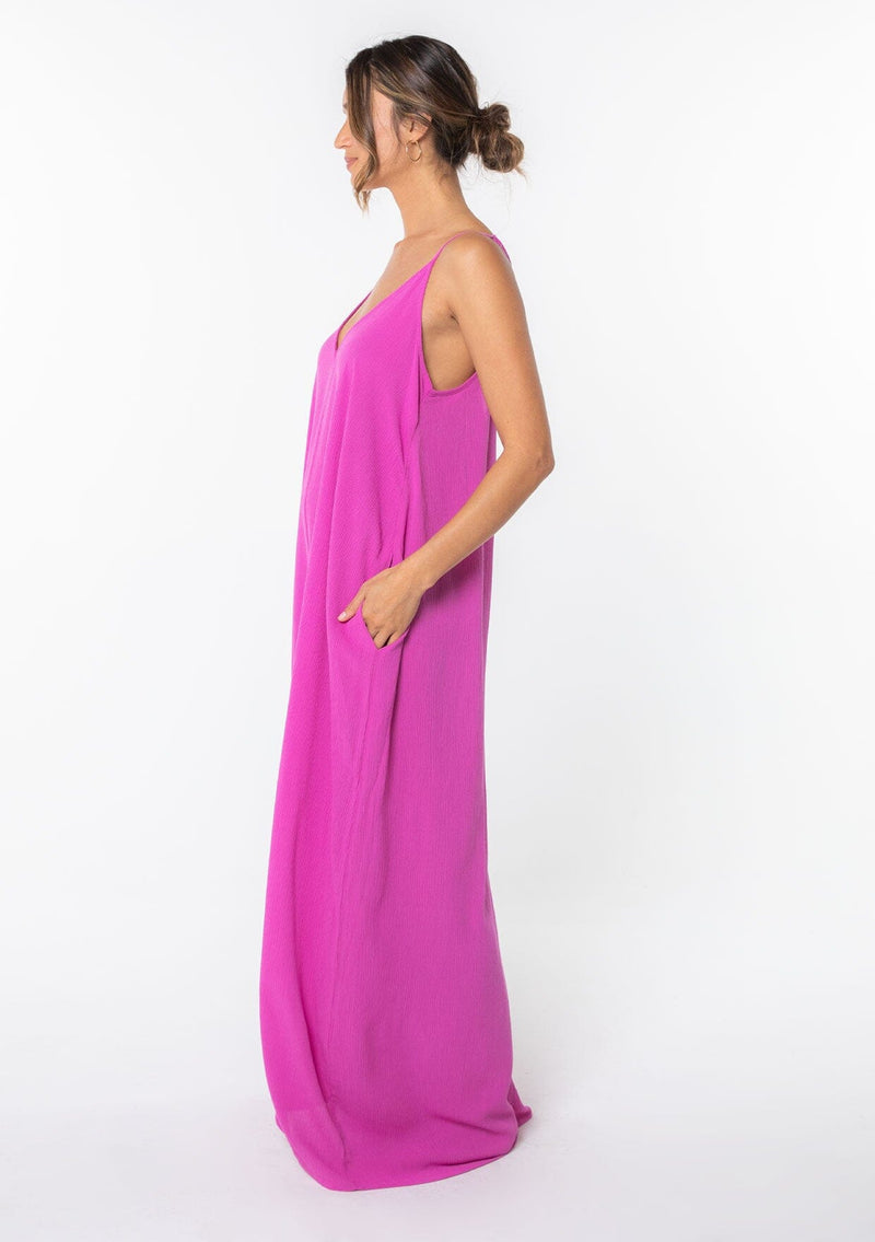 [Color: Purple] A bright purple harem maxi dress. This billowy maxi tank top dress features a deep v neckline, adjustable spaghetti straps, and a cocoon fit.
