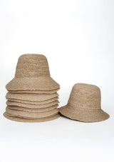Stack of woven hats on a white background