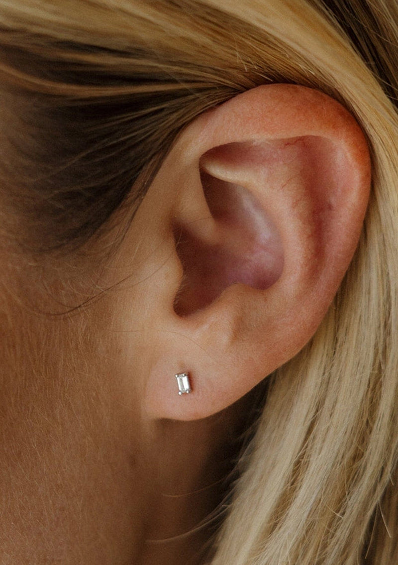 [Color: Silver/Clear:] Dainty .925 sterling silver with rhodium plated CZ clear baguette stud earrings. 