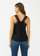 [Color: Black] A back facing image of a brunette model wearing our beloved lace trim camisole, now reimagined with elegant lace-trimmed straps and a sophisticated lace V-neckline. This versatile piece features a flattering racerback design with delicate pretty lace straps, making it the perfect layering essential.