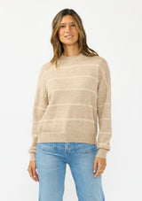 [Color: Heather Taupe] A front facing image of a brunette model wearing a brown striped pullover sweater with a striped design and a high neckline. 