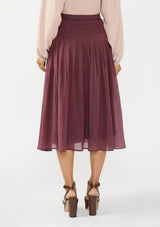 [Color: Plum] A back facing image of a model wearing a crinkled purple midi skirt with pleats. 
