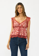 [Color: Wine/Dusty Rose] A front facing image of a brunette model wearing a wine floral print lace top with cap sleeves, v neckline, and a back button closure. 