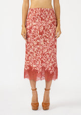 [Color: Wine/Dusty Rose] A front facing image of a red and white midi skirt with lace trim. Styled with a brown platform heel. 