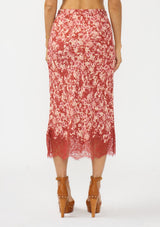 [Color: Wine/Dusty Rose] A back facing image of a red and white midi skirt with lace trim. Styled with a brown platform heel. 
