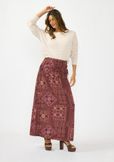 [Color: Birch] A front facing image of a brunette model wearing an off white chenille sweater with a round neck and long sleeves with dropped shoulders. Styled with the burgundy paisley  bohemian maxi skirt. 